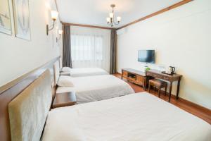 Postel nebo postele na pokoji v ubytování Memory Inn Guilin Central