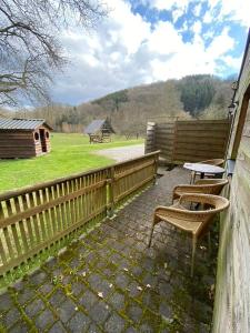 a patio with two chairs and a table and a fence at Forges de Pernelle in Couvin +31 photos