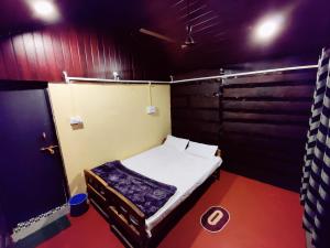 a small room with a small bed in it at patanga beach cottege in Gokarna