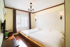 Postel nebo postele na pokoji v ubytování Memory Inn Guilin Central