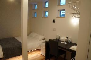 a room with a desk with a bed and a desk at SORAYADO 宙宿 in Tsuru 