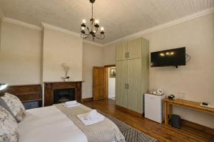 a bedroom with a bed and a tv on the wall at Haus Müller in Clanwilliam