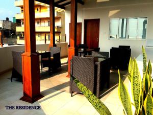 a restaurant with a table and chairs on a balcony at The Residence in Colombo