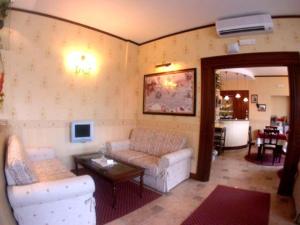 a living room with a couch and a table at Amaranto Hotel in Afragola