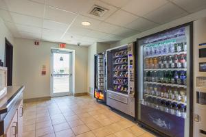 a store aisle with two refrigerators and bottles of alcohol at Motel 6-Whitby, ON - Toronto East in Whitby