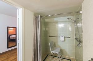 a shower with a chair in a bathroom at Motel 6-Wichita Falls, TX - North in Wichita Falls