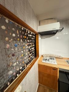 a kitchen with a wall of wine bottles at YADOKARI miyakojima in Miyako-jima +10 photos