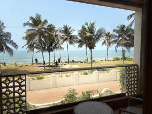 a view of the beach from a hotel room window at Peninsula Del Mar Beach Resort in Udupi +92 photos