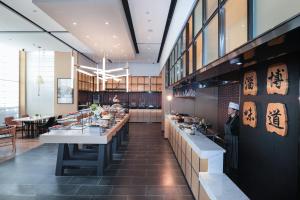 a restaurant with a buffet line in the middle of a room at Atour Hotel High Speed Railway North Station Zibo Hi tech Zone in Zibo +52 photos