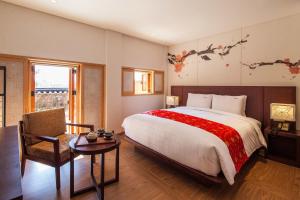 a bedroom with a large bed and a chair at Gyeongwonjae By Walkerhill in Incheon