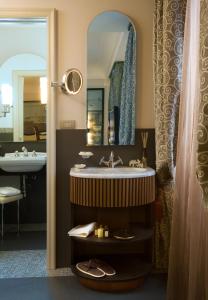 a bathroom with a sink and a mirror at Grand Hotel Savoia in Genoa