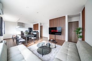 a living room with a couch and a table at Stellavia in Nakafurano