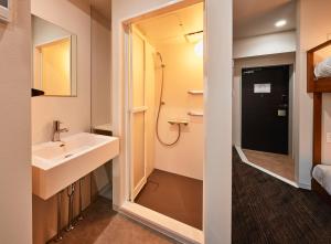 a bathroom with a sink and a shower at Moat Inside Tenjin in Fukuoka +34 photos