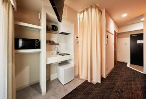 a small bathroom with a sink and a toilet at Moat Inside Tenjin in Fukuoka