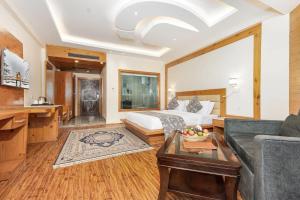a living room with a bed and a couch at Badar Resorts & Spa by Stay Pattern Riverside in Sonāmarg +30 photos