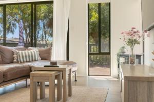 a living room with a couch and a table at Viaggio Sul Mare in Baudin Beach
