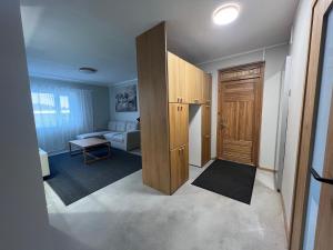 a living room with a large wooden closet and a living room at Emmaste Apartment in Emmaste