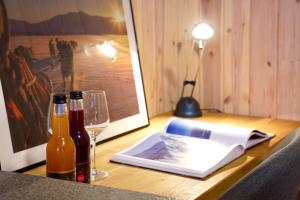 a table with two bottles and a glass of wine at Ingridstua Huskyfarm Innset in Bardu
