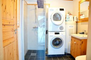 a washer and dryer in a small bathroom at Ingridstua Huskyfarm Innset in Bardu +20 photos