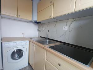 a small kitchen with a sink and a washing machine at Guest House Cela in Çorovodë +21 photos