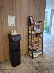 a book shelf next to a stove in a room at Hotel Centrum in Bolesławiec