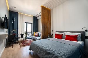 a bedroom with a large bed with red pillows at Blueloft 52 I Tashkent City Center in Tashkent