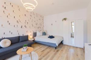 a living room with a couch and a bed at Stadtoase Chemnitz in Chemnitz +30 photos
