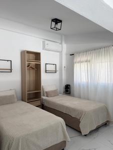 a bedroom with two beds and a window at Anastasia B in Ofrínion