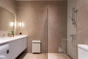 a bathroom with a shower with a glass door at Blueloft 52 I Tashkent City Center in Tashkent +24 photos