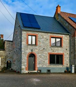 a house with solar panels on the roof at La Petite Auberge de Graux in Mettet