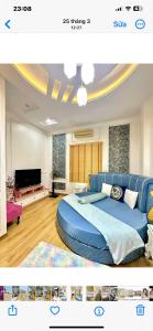a bedroom with a blue bed and a tv at Luxury hotel t&l in Cẩm Phả +15 photos