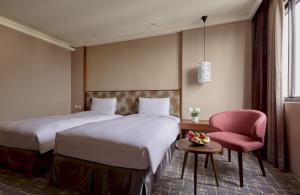 Katil atau katil-katil dalam bilik di Orange Hotel - Wenhua, Chiayi