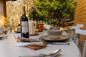 a bottle of wine sitting on top of a table at Chalet et étang, exclusivement privée in Manzat