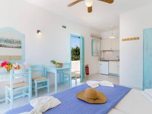 a room with a table with a hat on it at Makrigialos Apartments und Studios in Makry Gialos