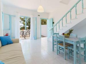 a living room with a blue table and chairs at Makrigialos Apartments und Studios in Makry Gialos