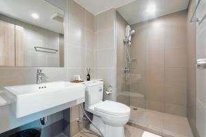 a bathroom with a toilet and a sink and a shower at The View Chaengwattana 14 in Bangkok +25 photos