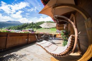 a deck with chairs and tables on a balcony at Pension Sonnenheim in Sölden