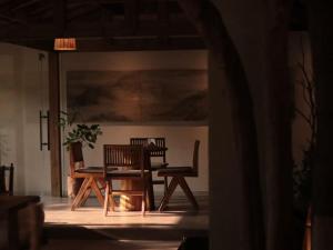 a table and two chairs and a table and a bench at Shishe Spring Designer Homestay in Dujiangyan