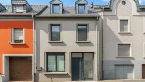 an apartment building with orange and gray at Beautiful Design 2 BR Loft in Mertert