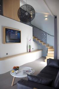 a living room with a staircase and a table at Relais De L'abbaye in Charlieu