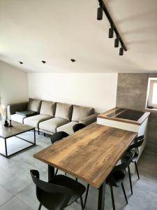 a living room with a table and a couch at Artistik in Vodice