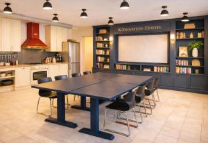 a kitchen with a table and chairs and a chalkboard at Königstein Hostel in Königstein an der Elbe +31 photos