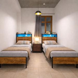 a room with two beds and a lamp in it at Königstein Hostel in Königstein an der Elbe