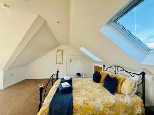 a bedroom with a bed and a large window at Stylish 3 Bed Apt Sea Views Near the Beach 2B in Felixstowe +72 photos