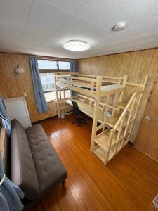 a living room with two bunk beds and a couch at YADOKARI miyakojima in Miyako-jima