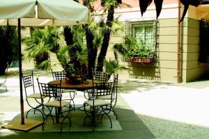 a table and chairs under an umbrella on a patio at Alassio White Loft in Alassio