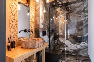 a bathroom with a wooden sink and a shower at Tatra Heaven Residence & Jacuzzi in Kościelisko +25 photos