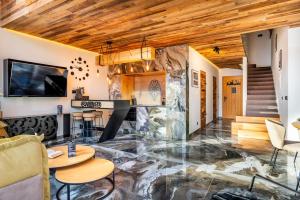 a living room with a marble floor and wooden ceilings at Tatra Heaven Residence & Jacuzzi in Kościelisko