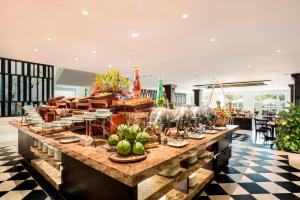 a buffet in a restaurant with dishes on a table at Boutique Hoi An Resort in Hoi An