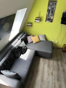 a living room with a black couch in the corner at Apartment Luna in Bovec +16 photos